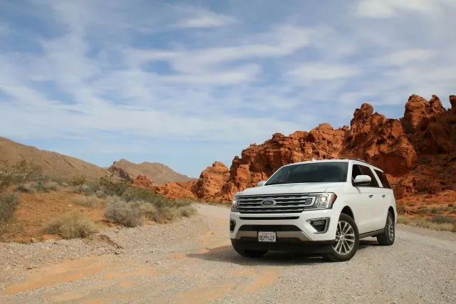 4WD car driving on a dirt road, symbolizing the benefits of a low doc car loan.