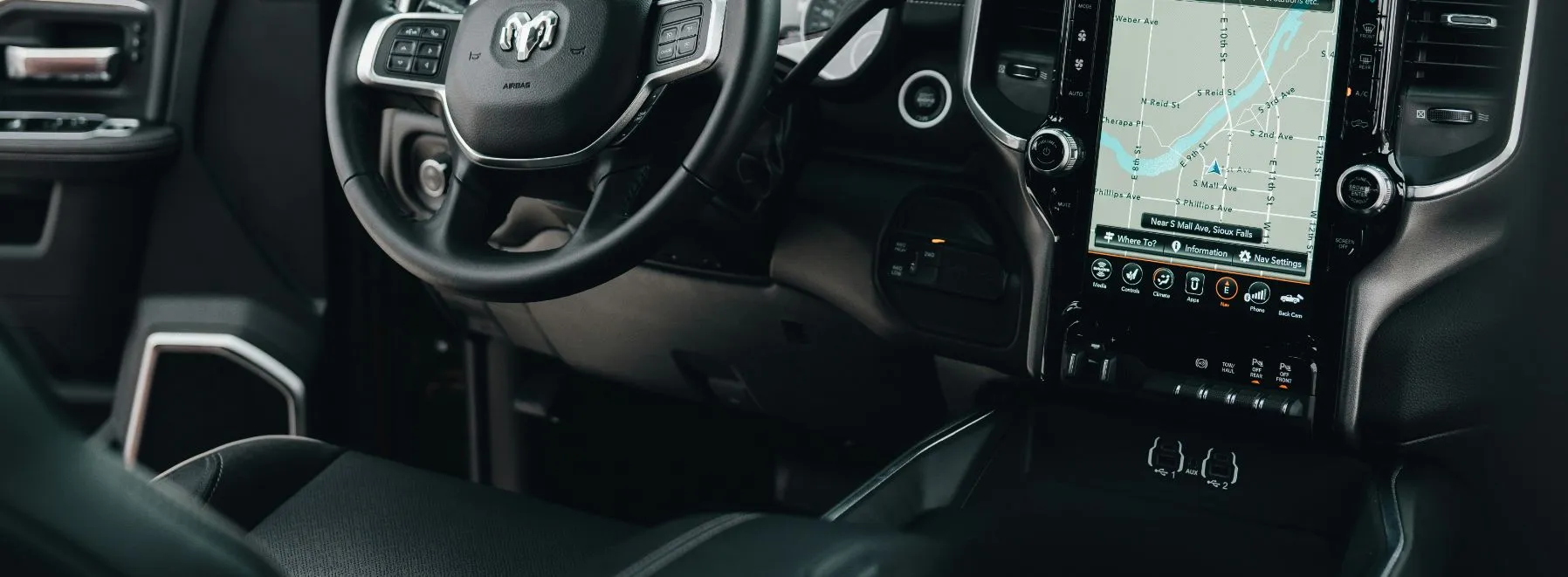 Car steering wheel and map on console, symbolizing the navigation of secured car loans with AAA Finance.