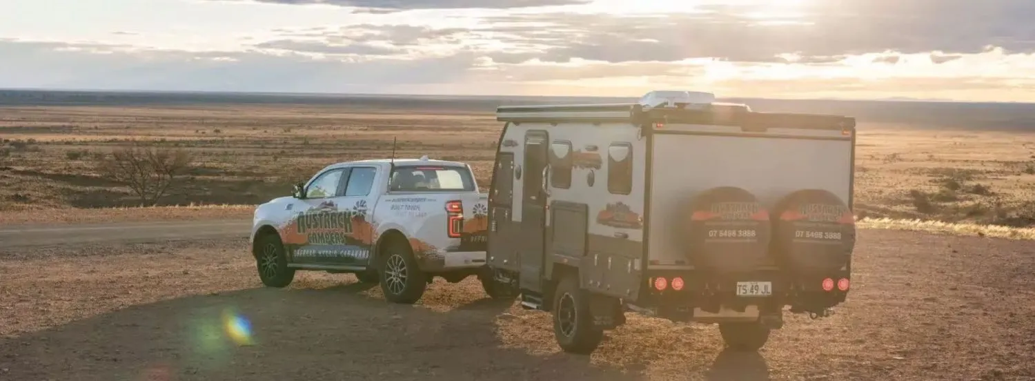 Austrack camper towed by 4WD at sunset – Secured Caravan Loan with AAA Finance