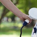 Electric Vehicle Plugging In to Charge | AAA Finance