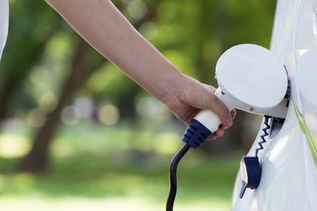 Electric Vehicle Plugging In to Charge | AAA Finance