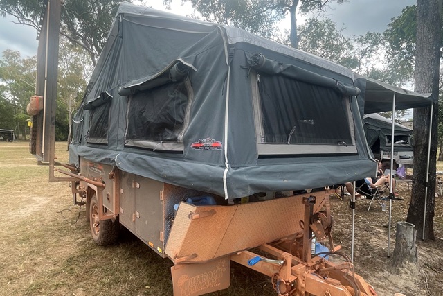 Austrack camper set up on the red dirt at Bramwell Station during Brian’s Cape York adventure.