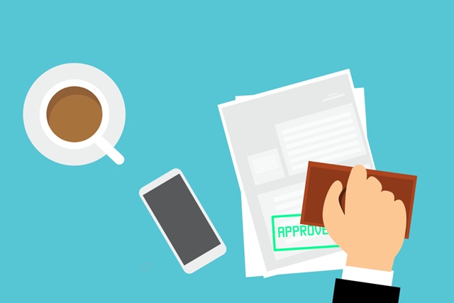 Illustration of an approved car loan application form with a bold “approved” stamp, coffee cup, and mobile phone on the desk – representing how easy it is to apply for a car loan.