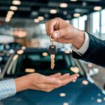 Car dealership handing over keys to a customer after low doc vehicle finance approval using AAA Finance