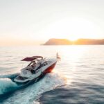 Boat motoring into the sunset, representing recreational vehicle finance for lifestyle and adventure purchases